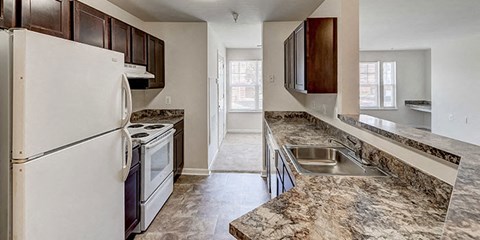 a kitchen with white appliances and granite counter tops