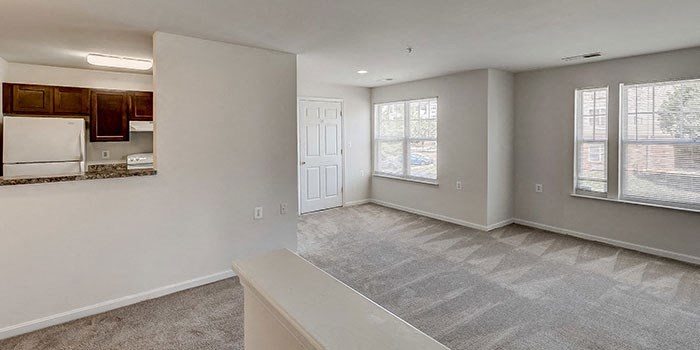 An empty apartment with bright windows at Windsor Crossing, Suitland, MD 