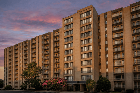 A large apartment building with balconies and windows is shown.