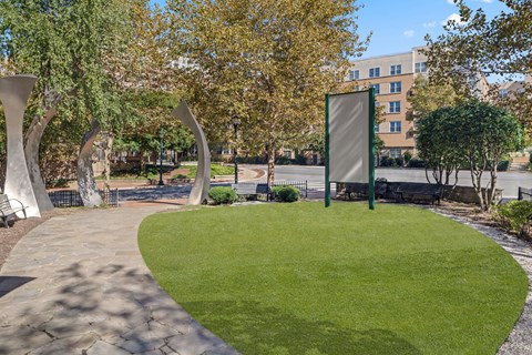A park with a grassy area and a walkway.