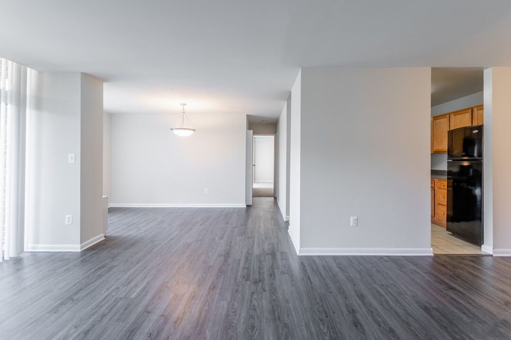 A spacious room with wooden flooring and white walls at Charlestowne North Apartments, Maryland, 20770