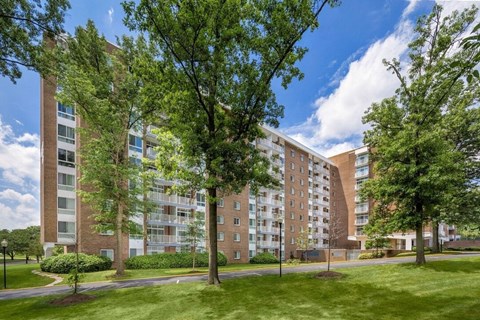 A large apartment building with a green lawn in front at Charlestowne North Apartments, Maryland, 20770