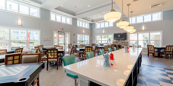 A restaurant with tables and chairs and a checkered floor. at Rainier Manor Apartments, Maryland