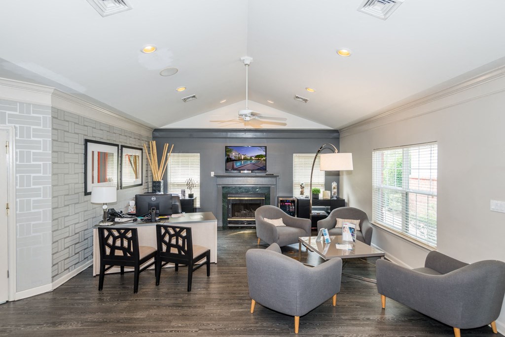 leasing office with hardwood floors, chairs, desk, and TV at Governors Green, Bowie