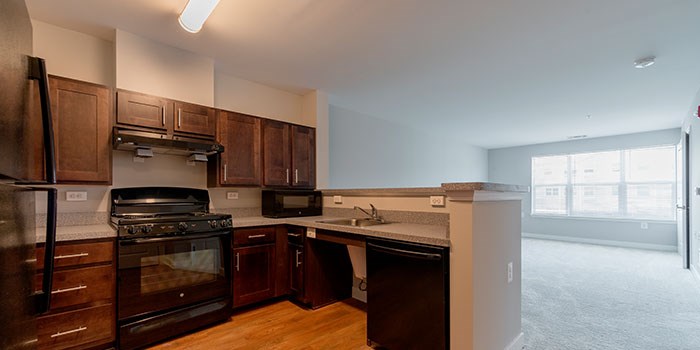 A kitchen with dark wood cabinets and appliances. at Rainier Manor Apartments, Mount Rainier