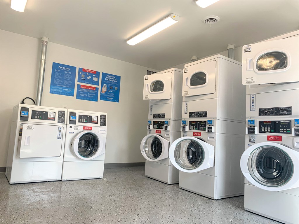 a row of washing machines in a laundry room