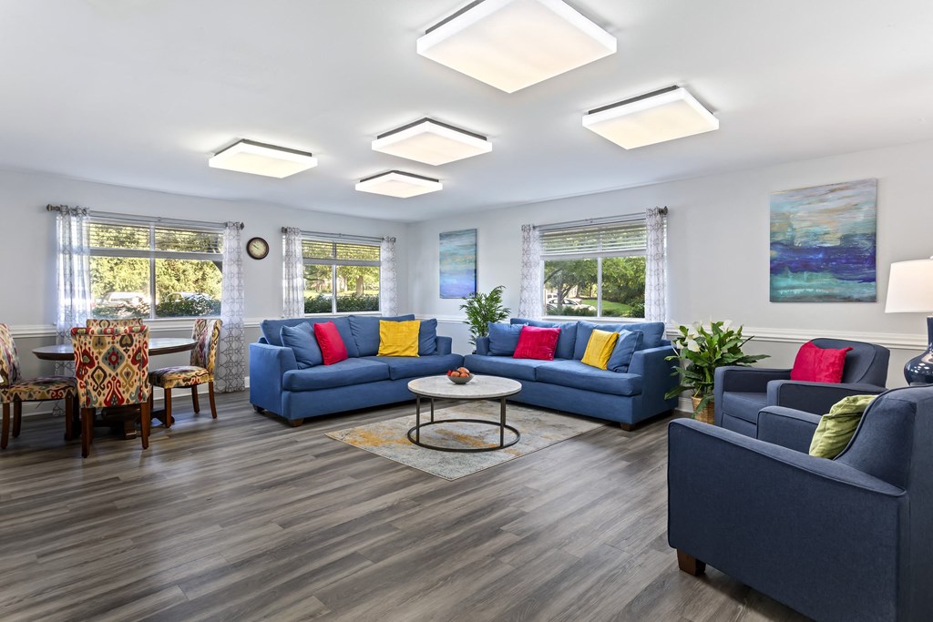 community space at Creekside at Taskers Chance in Frederick, MD  with blue couches, chairs and a coffee table