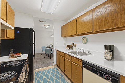 a kitchen with a dishwasher and a sink and a refrigerator