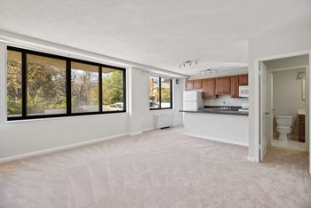 A large, empty room with a kitchen in the background at The Brittany, Washington, DC, 20015