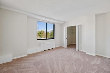 A room with a carpeted floor and a window at The Brittany, Washington, DC, 20015