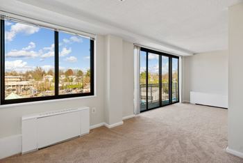 A room with a large window and sliding glass doors at The Brittany, Washington, DC, 20015