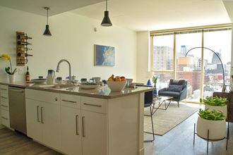 a kitchen and living room with a large window