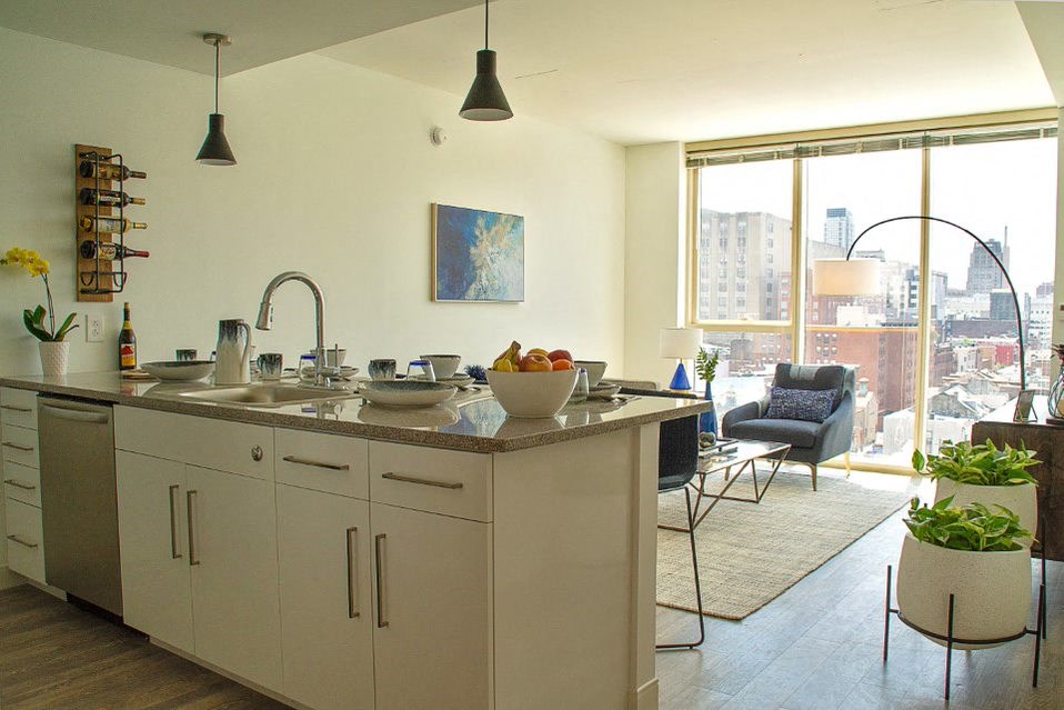 a kitchen and living room with a large window