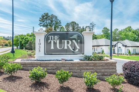 The Turn 103 sign is in front of a building.