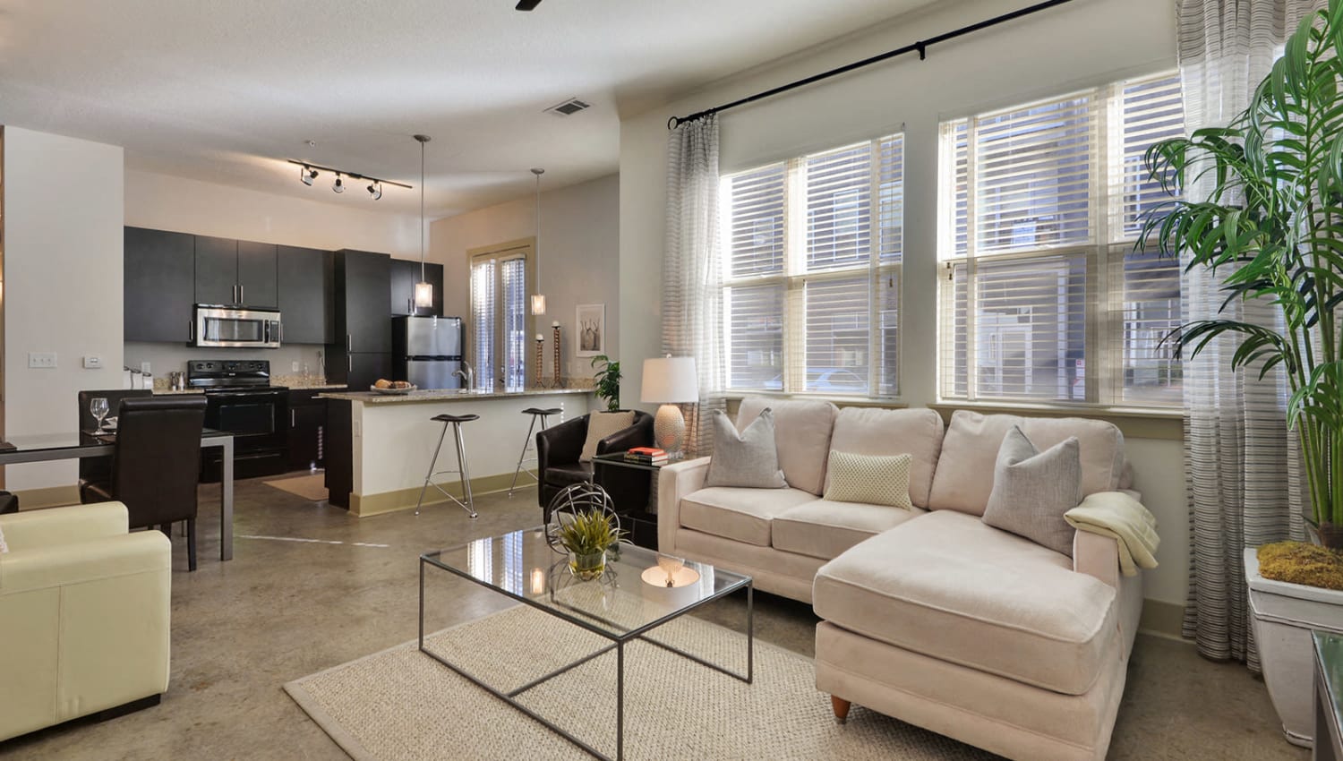 a living room with a couch and a glass table