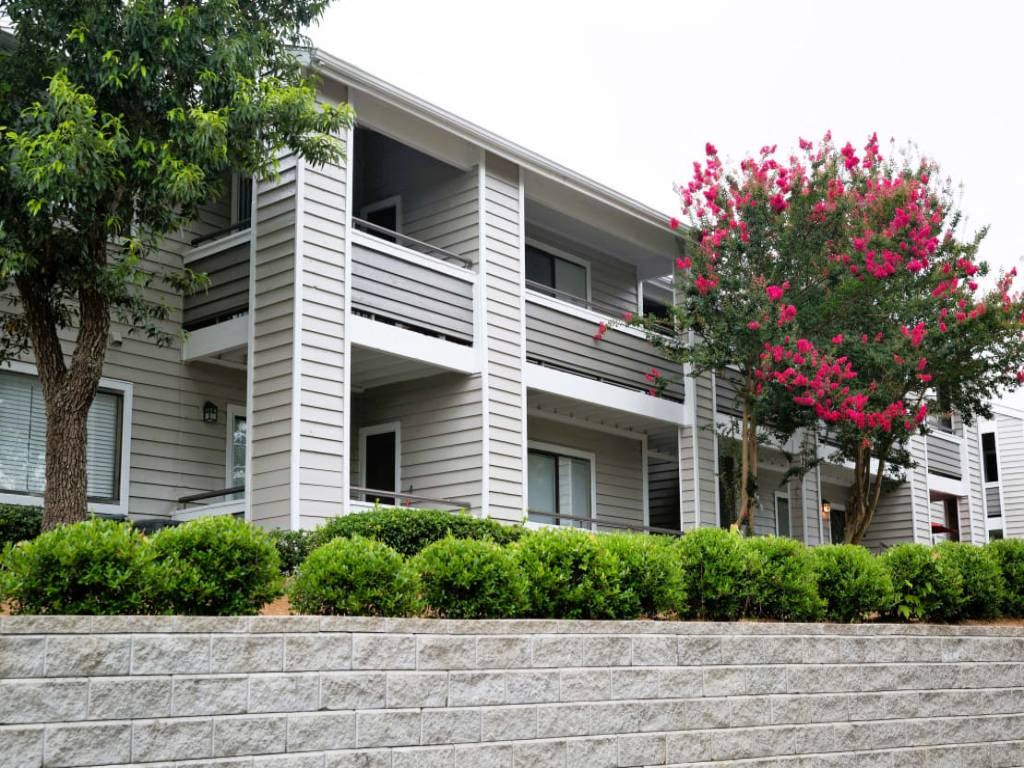 a white apartment building with balconies and a staircase