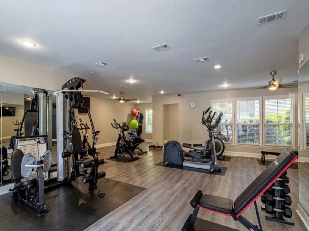 the gym is equipped with cardio equipment and weights
