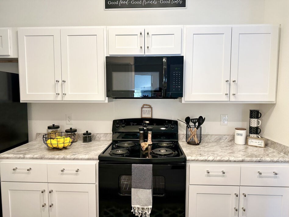 A black stove top oven with a towel on it.