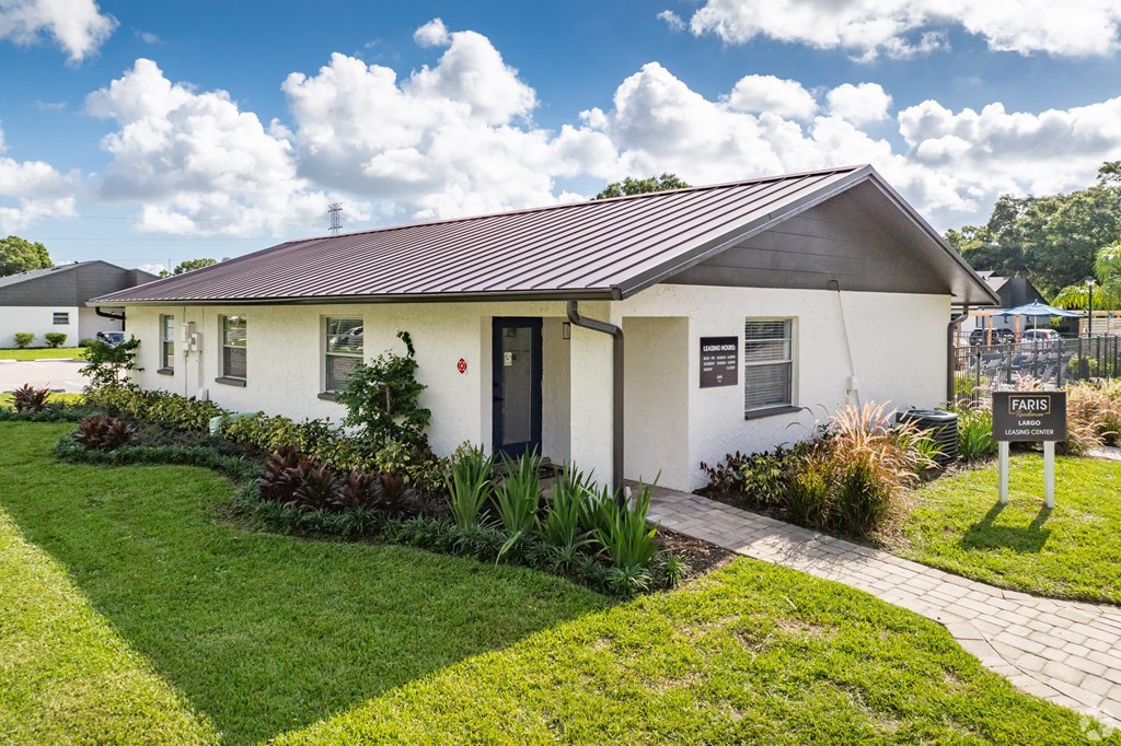 A white house with a red roof and a sign that says Paris.