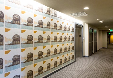 A hallway with a wallpaper design of domed buildings.