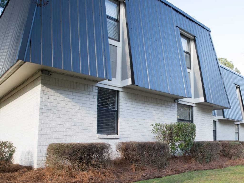 the side of a house with a blue roof