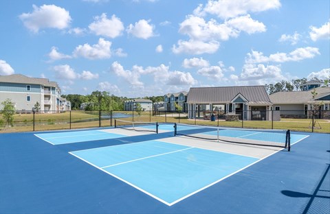 A tennis court with a blue surface and white lines.