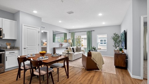 A dining room with a table set for a meal.