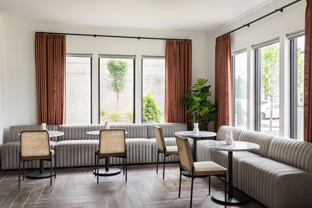 a living room with couches chairs tables and windows at The Cannon, Murfreesboro, TN