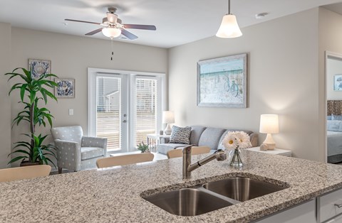 A kitchen with a granite countertop and a sink.