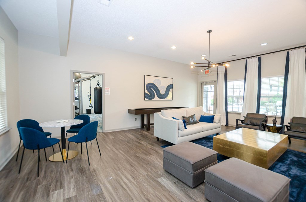 a living room with couches and chairs and a table