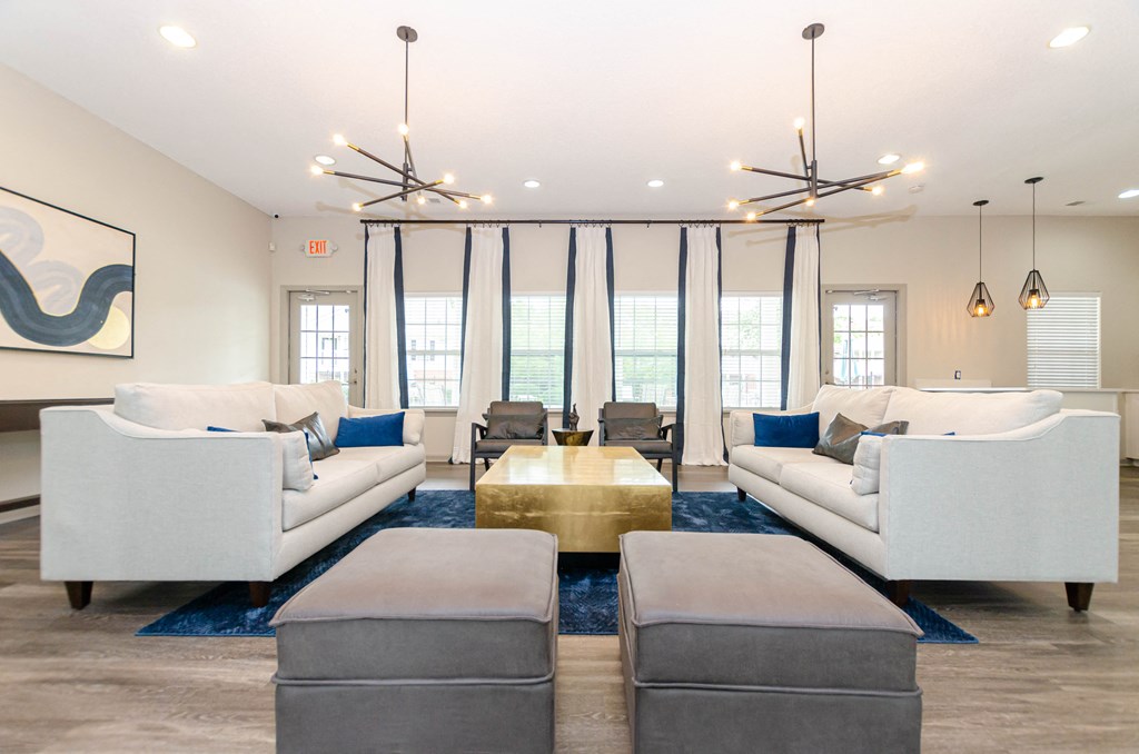 a living room with couches and chairs and a table