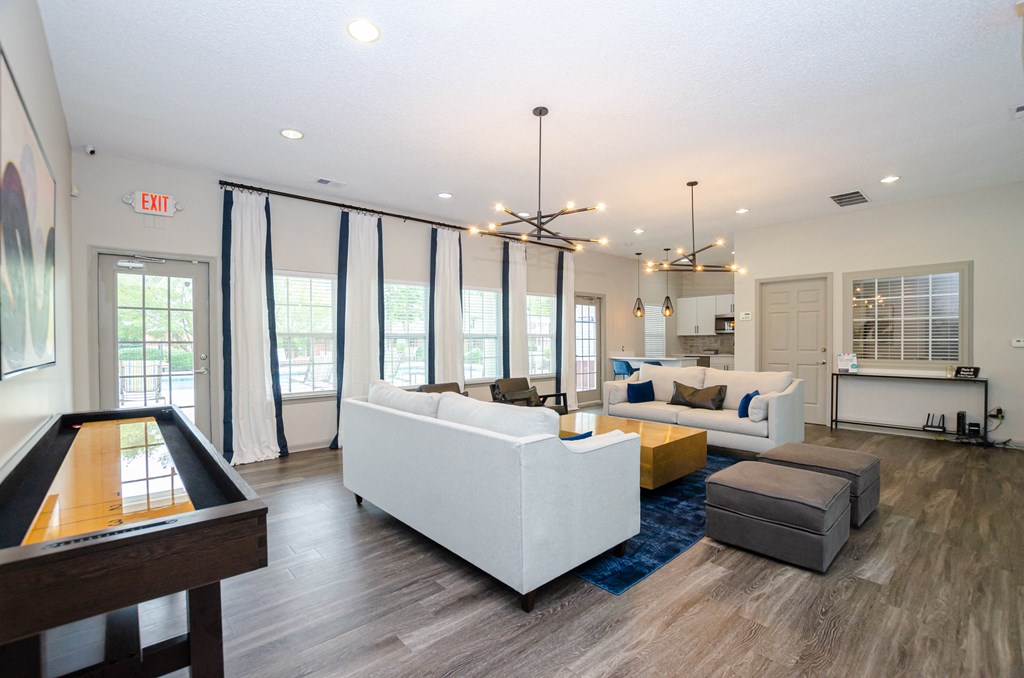 a living room with couches and chairs and a table