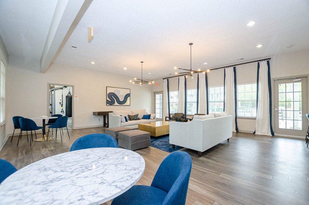 a living room with couches and a table and chairs