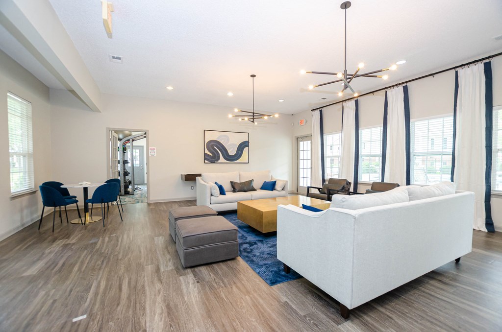 a living room with couches and a table and chairs