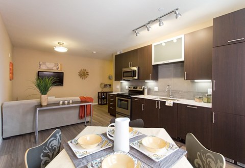 A kitchen with a table set for two.