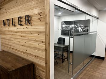 a office with a glass door with a car on it