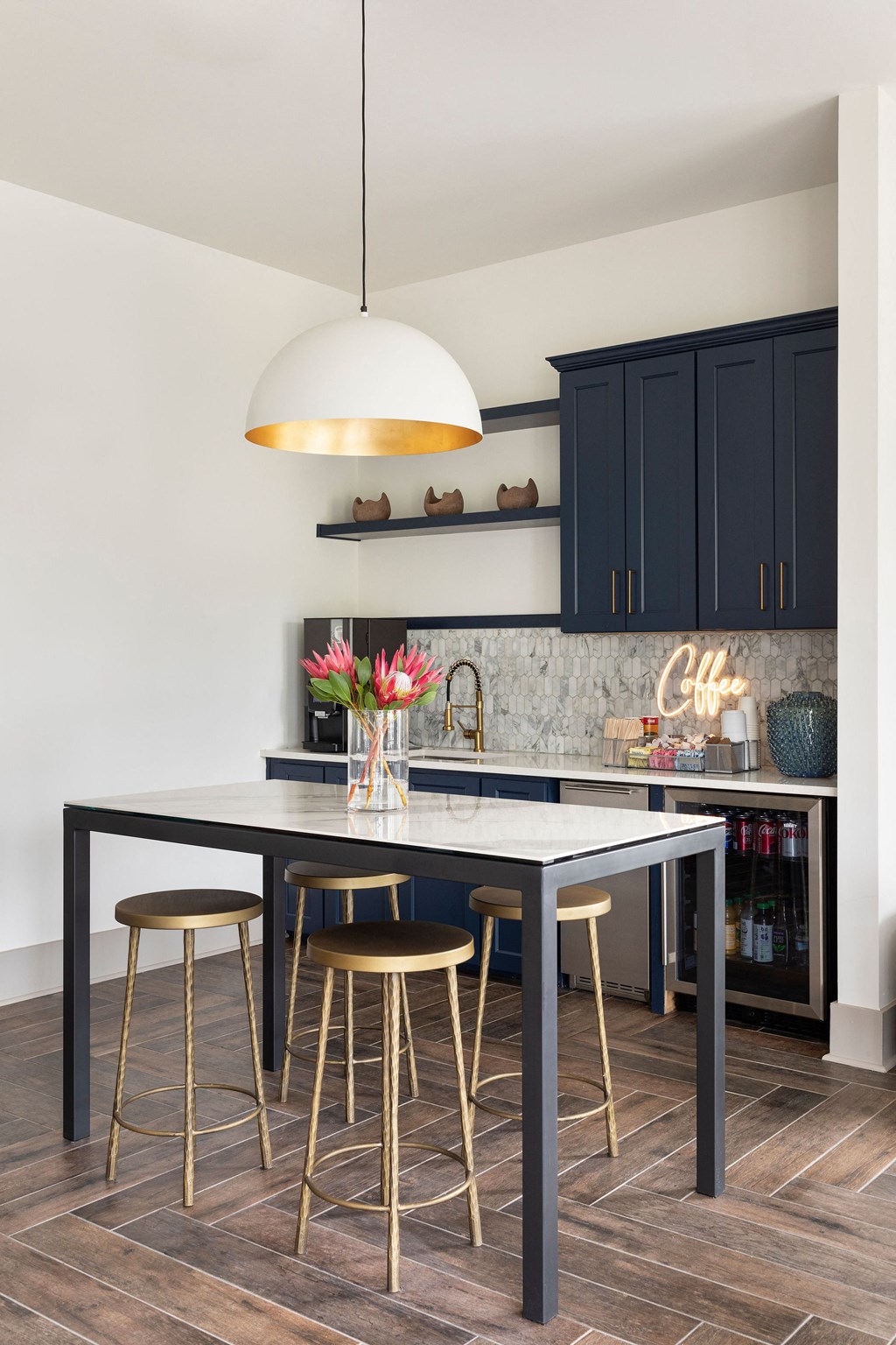 a kitchen with a black island and three stools at The Cannon, Murfreesboro, TN