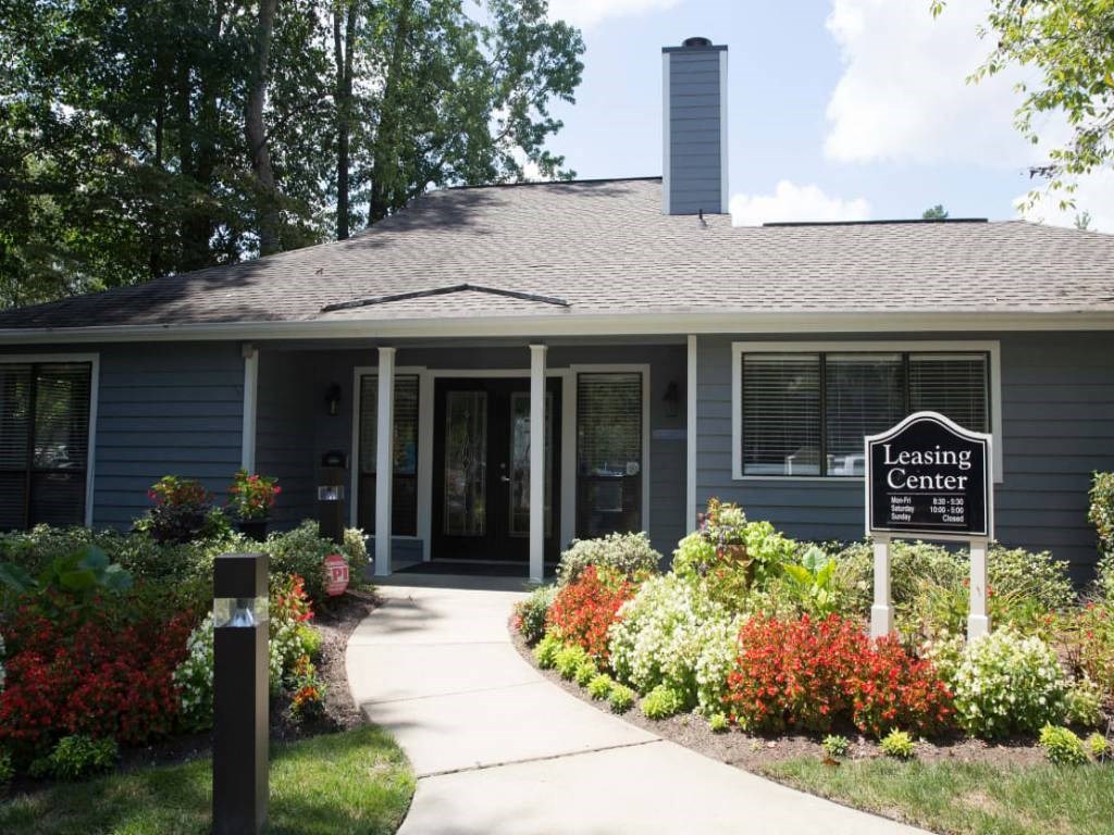 a building with a leasing center sign in front of it