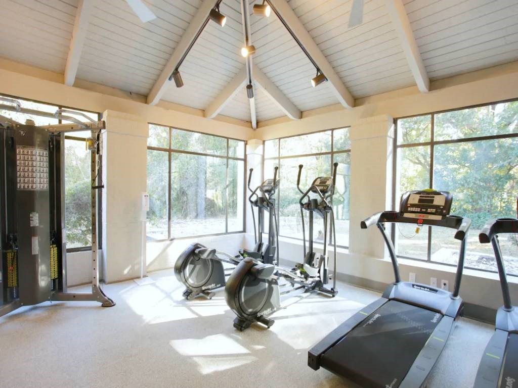 the gym has plenty of windows and a view of the woods