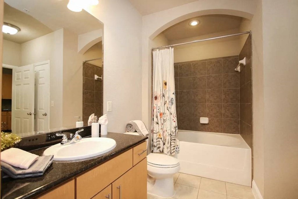 a bathroom with a sink toilet and bathtub at Kings Cove, Kingwood