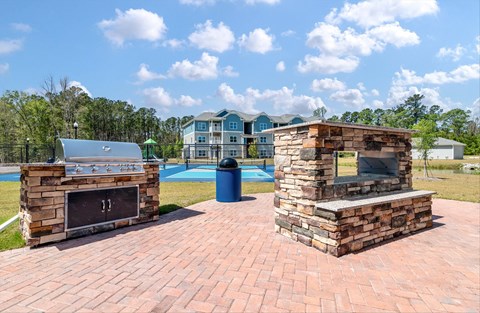 A brick fireplace with the number 11 on it sits on a brick patio.