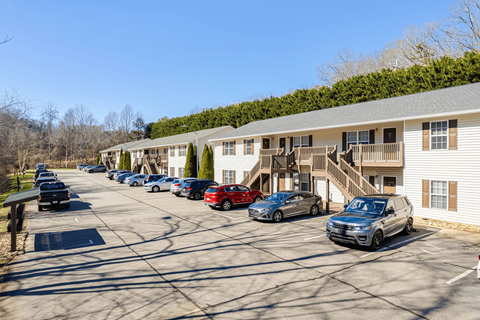 a parking lot with cars parked in front of a building
