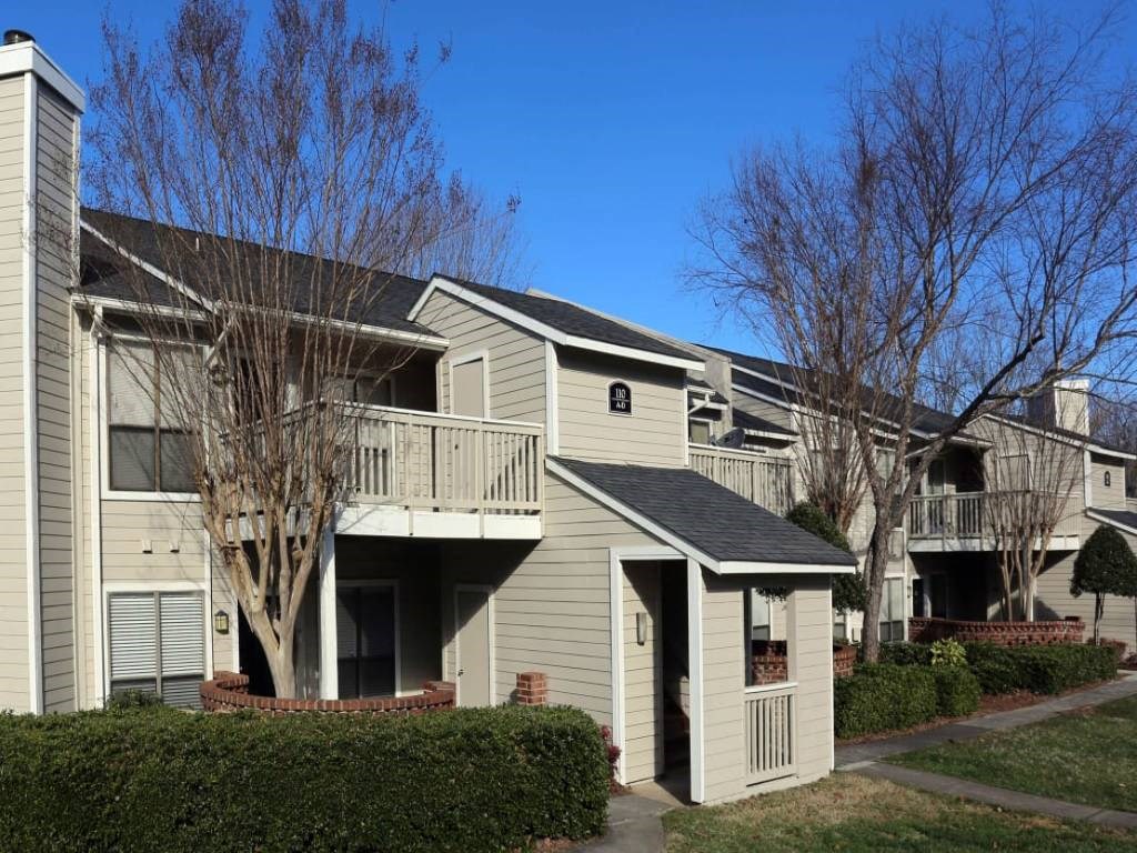 a group of apartments with balconies and trees
