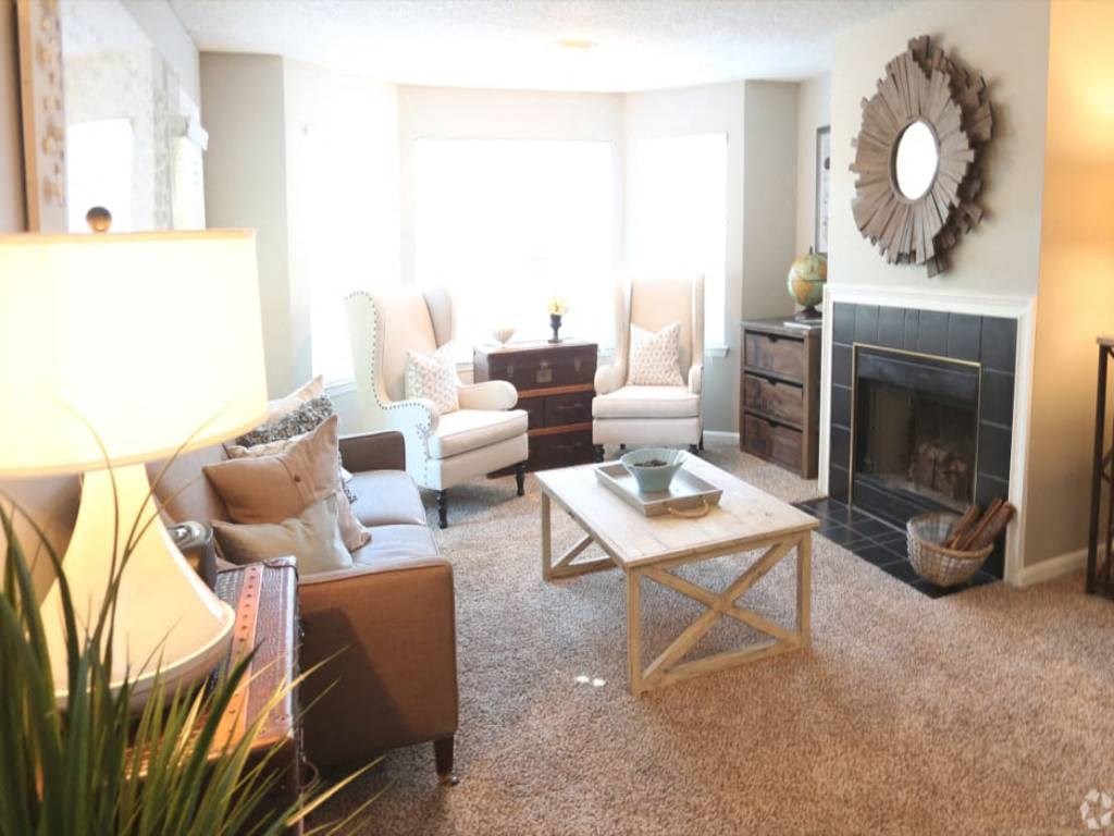 a living room filled with furniture and a fireplace