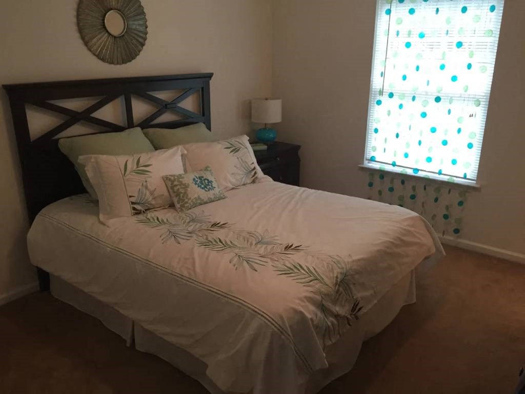 bedroom with a queen sized bed and a window