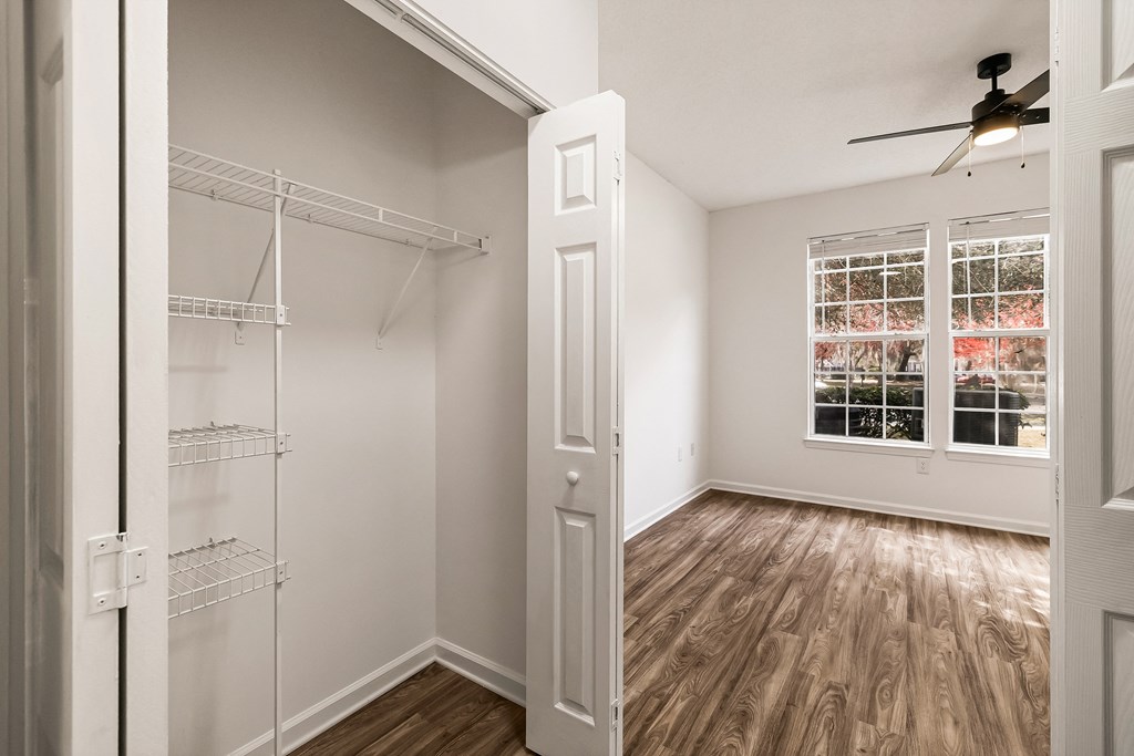 A room with a window and a ceiling fan.