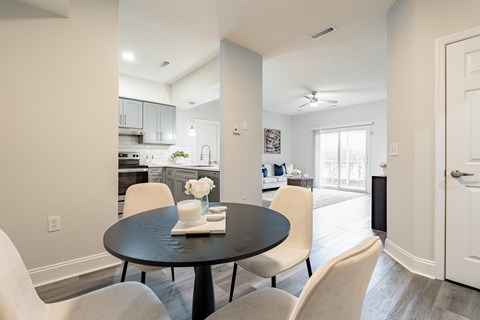A dining room with a table set for two.