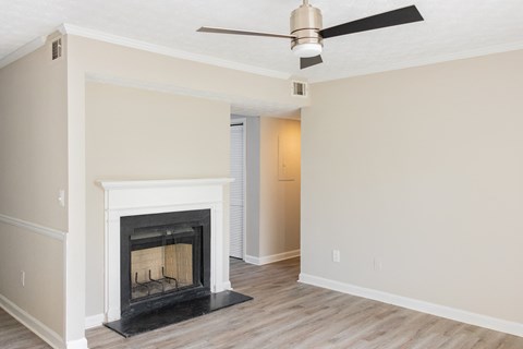 Living space with fireplace and ceiling fan at Twin Springs, Norcross, GA