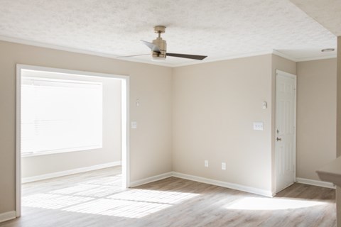 Spacious living room with ceiling fan at Twin Springs Apartments, Norcross, GA
