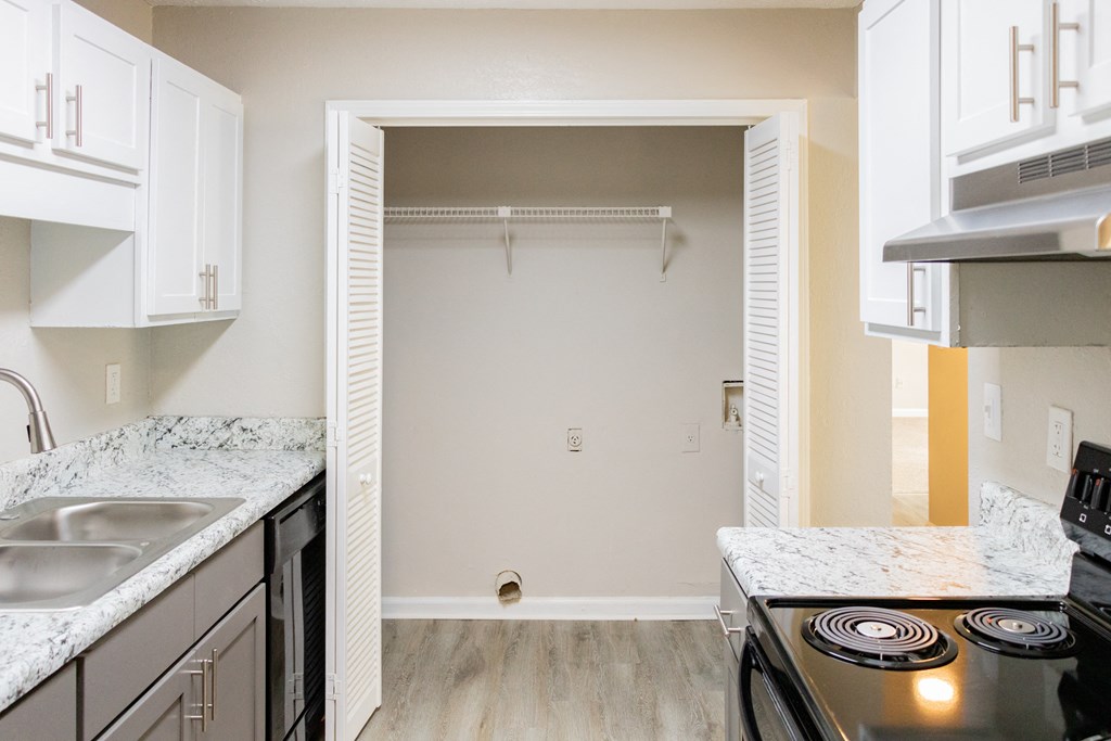 Spacious kitchen with white cabinets and black appliances at Twin Springs, Norcross, GA